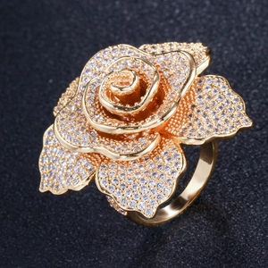 Macro shot of rose flower ring with gold plating and paved white cubic zirconia