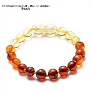 Detailed macro view of multi-colored Baltic amber beads in a rainbow gradient bracelet