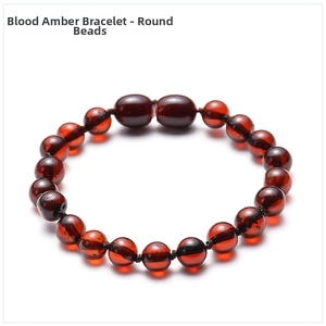 Macro shot of natural Baltic blood amber round beads showing translucent deep red texture