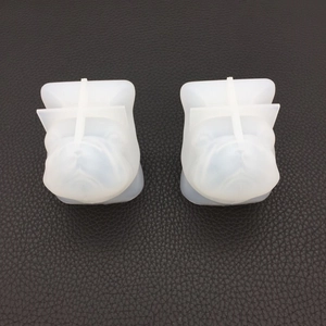 Detailed macro view of two 3D French Bulldog head silicone molds for resin or plaster DIY