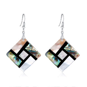 Close-up of geometric square drop earrings with iridescent shell inlay and silver hooks