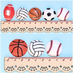 Mixed large resin sports ball charms including football and basketball on a blue background