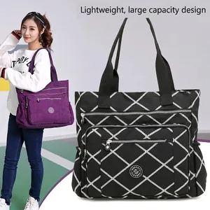 Large black nylon tote bag with white diamond pattern and multiple functional pockets