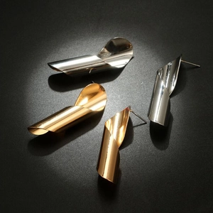 Exaggerated irregular spiral metal earrings in shiny gold and silver finishes