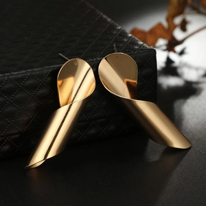Elegant gold spiral earrings with irregular wavy design on a luxury black jewelry box