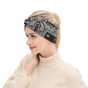 Detail of bohemian paisley print twisted headband with elastic stretch fabric on model