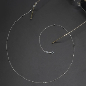 Macro shot of silver metal beaded glasses chain with flexible white silicone loops