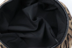 Detailed close-up showing the leopard print wool fabric and black removable inner lining