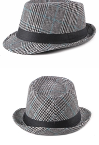 Detail of British style houndstooth fedora hat featuring blue plaid and black satin band