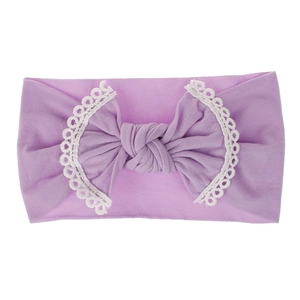 Detailed view of a soft purple baby nylon headband with a lace-trimmed bow.