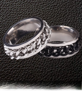 Detail of rotatable stainless steel chain rings in silver and black on leather