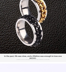 Macro view of punk rotatable bottle opener rings with gold and black Cuban chains