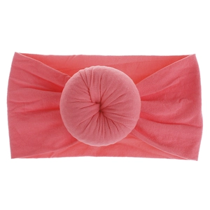 Dettaglio fascia neonata rosa in nylon con nodo a ciambella e morbida trama a maglia