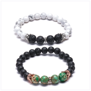 Close-up of white turquoise and lava stone bracelets with micro-pave crown charms