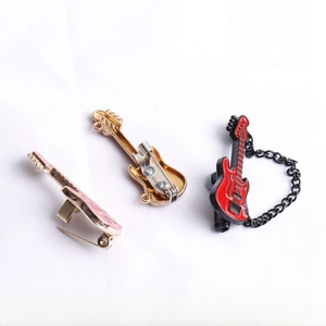 Detailed view of colorful guitar pins in pink, gold, and red with fine enamel finish
