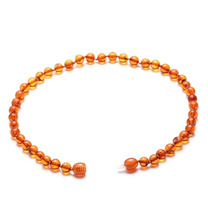 Natural Baltic amber bead necklace for babies with secure screw clasp on white background