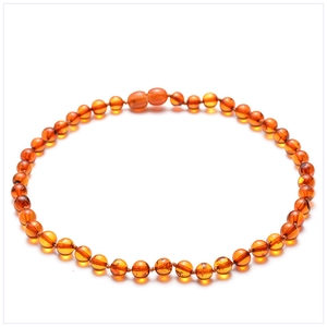 Detailed view of natural Baltic amber beads showing translucent cognac textures and details