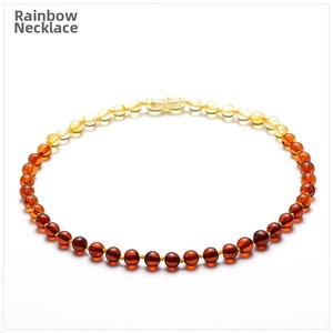 Detail of Baltic amber baby necklace showing rainbow gradient beads and screw clasp