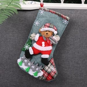 Christmas stocking with 3D teddy bear figure in red festive outfit and plaid scarf