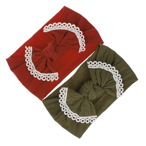 Detail of burgundy and olive green baby headbands with delicate lace-edged bows