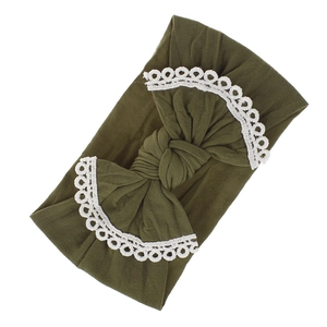 Detailed view of soft olive green nylon baby headband featuring a white lace bow