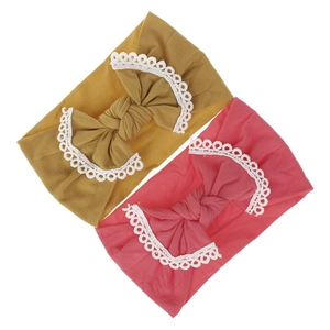 Detail of baby nylon headbands with oversized ginger and pink lace edge bows