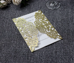 Macro shot of gold glitter laser-cut 40th birthday invitation with white paper insert