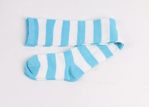Close-up of blue and white striped knitted over-knee sock in a flat lay studio view