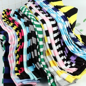 Close-up of assorted cotton striped over-knee socks in a white metal basket