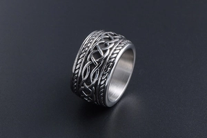 Macro detail of silver vintage punk style ring with carved Celtic knot patterns