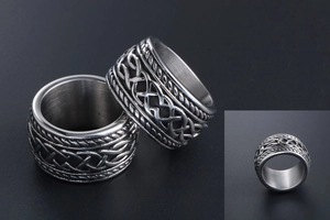 Detail view of vintage Celtic weave textured stainless steel rings for men in silver