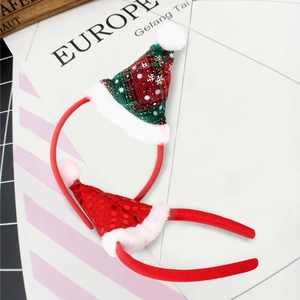 Detail of red Christmas headbands with glittery mini hats and snowflake patterns