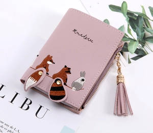 Detail of pink PU leather wallet with animal embroidery, fringe zipper, and snap closure