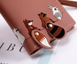 Close-up of pink PU leather wallet featuring detailed fox and rabbit animal embroidery