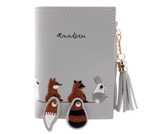 Detail of grey short wallet featuring cute animal embroidery with tassels and snap tails