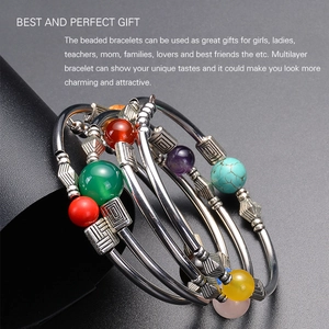 Detail of bohemian multilayer bracelet with colorful beads and silver engraved tubes