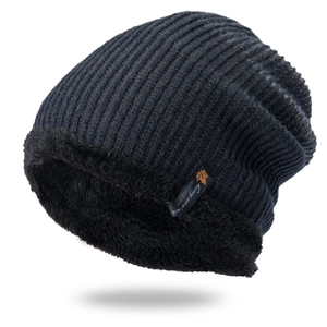 Detail of navy blue ribbed knit beanie featuring thick black fleece lining and maple leaf tag