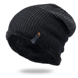 Detail of winter beanie showing thick black knit texture and warm fleece lining