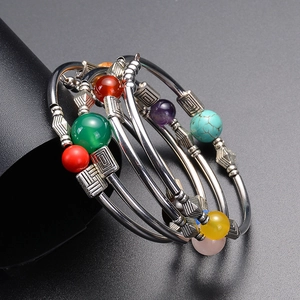 Detail of bohemian multilayer beaded bracelet with colorful stones and vintage silver spacers