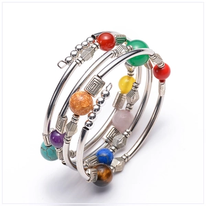 Macro shot of multi-layer chakra beaded bracelet with natural turquoise and stones