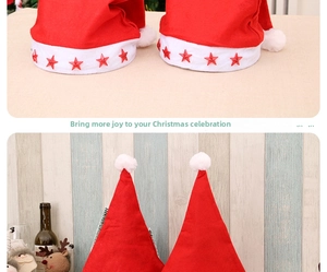 Detail of red Christmas hat featuring glittery stars and a white plush pom-pom top