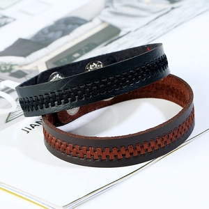 Minimalist black and brown leather bracelets with braided texture and snap closure