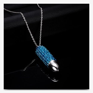 Detail of blue rhinestone bullet pendant on a silver-tone stainless steel chain