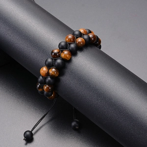 Detail of adjustable double-layer tiger eye and matte black stone beaded bracelet