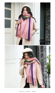 Detail of pink scarf with rainbow stripes and long tassels in a soft cashmere-like texture