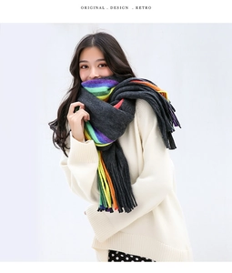 Detailed shot of rainbow striped cashmere scarf with long fringe and thick knit texture