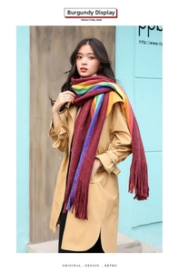 Detail of wine red rainbow striped scarf with long fringes shown on a model