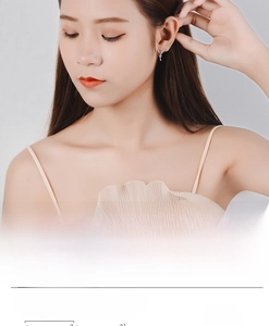 Detail view of angel wing heart earrings with 10mm width measurement for women