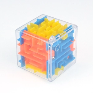 Detail of 3D maze cube showing internal multi-colored tracks and a small steel ball