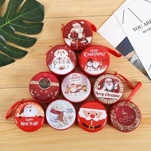 Detailed top view of 10 festive Christmas tin coin purses on a light wood background